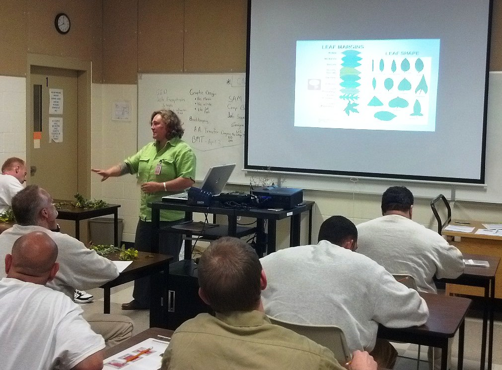 Gretchen Graber, Native Plant Greenhouse Manager for Washington State University (WSU), giving a presentation on native and invasive plants.