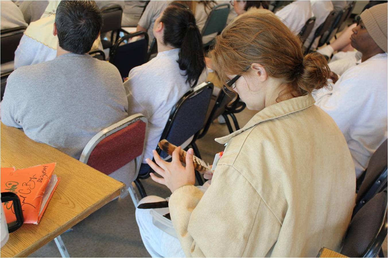 Inmates had the opportunity to examine some red-tailed hawk feathers during the presentation. Photo by Rachel Stendahl.
