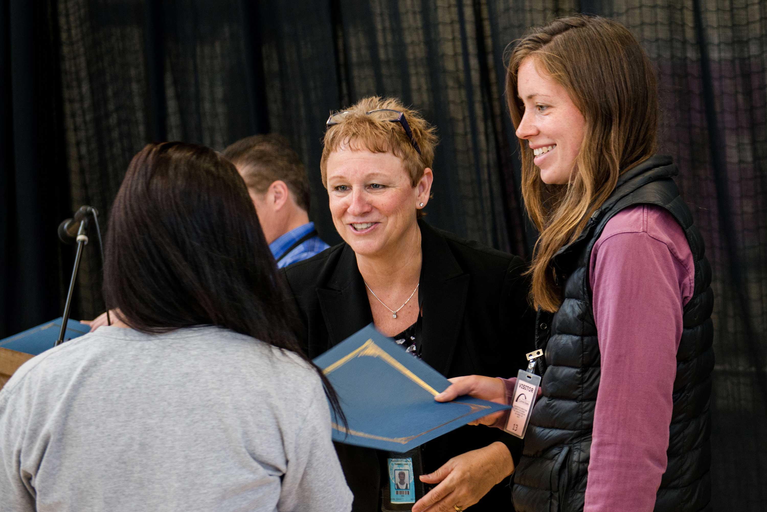 Jane Parnell, Superintendent of WCCW, presents an inmate technician with a certificate of appreciation at an awards ceremony