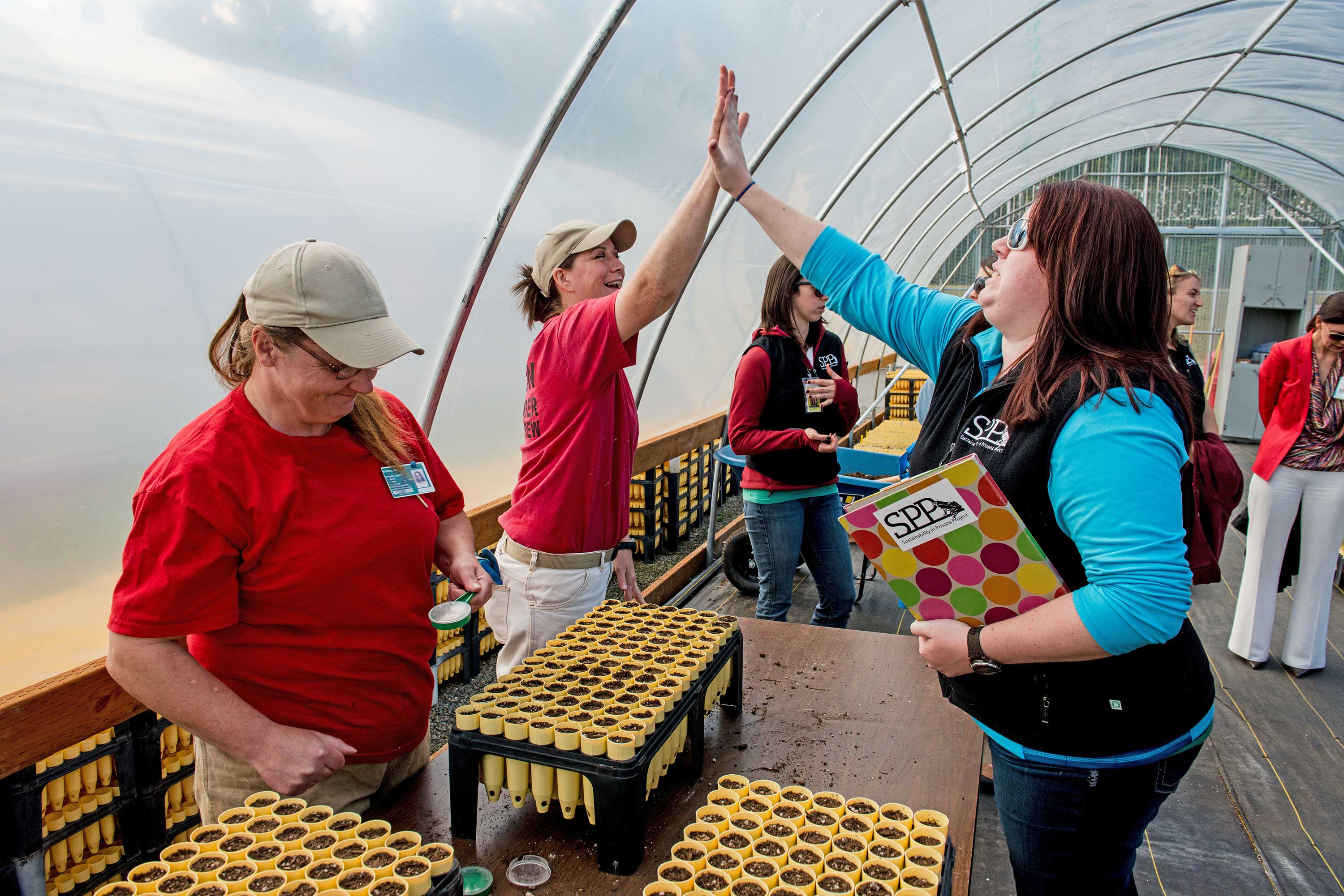 SPP Graduate Research Assistant Bri Morningred enjoys a moment of success with an inmate technician in the conservation nursery
