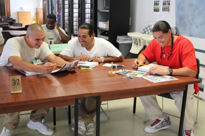 Students in the Roots of Success class at Cedar Creek Corrections Center work in a small group to address a study question. Photo by Erica Turnbull.