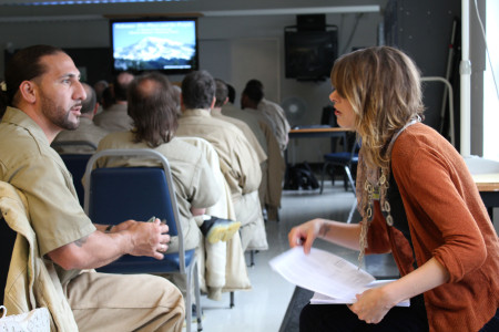 Tiffany Webb talks with an inmate during the lecture.