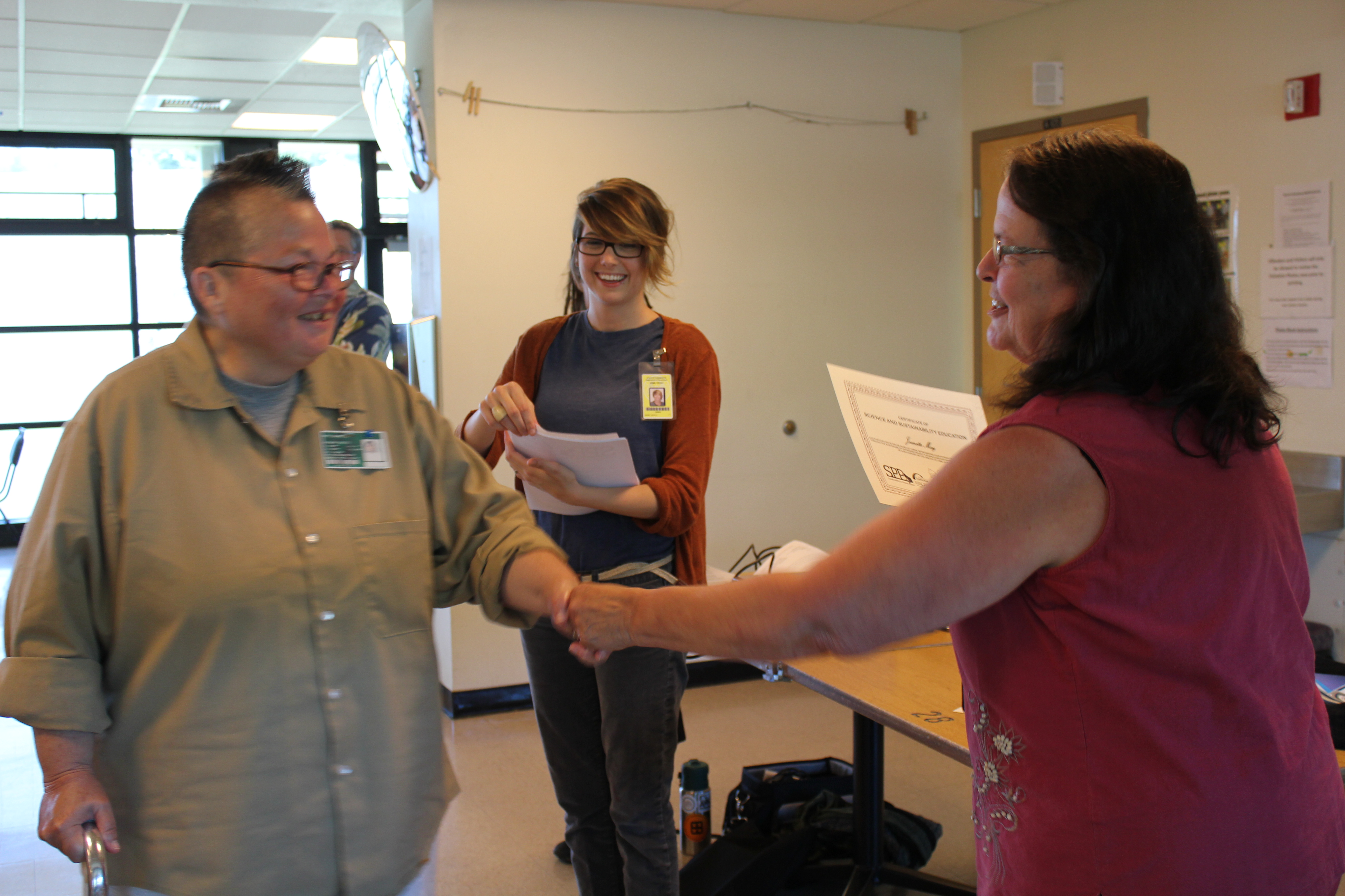 Presenting one of the first rounds of certificates to inmates who regularly attend the lecture series. Photo by Joslyn Trivett, SPP Network Manager.