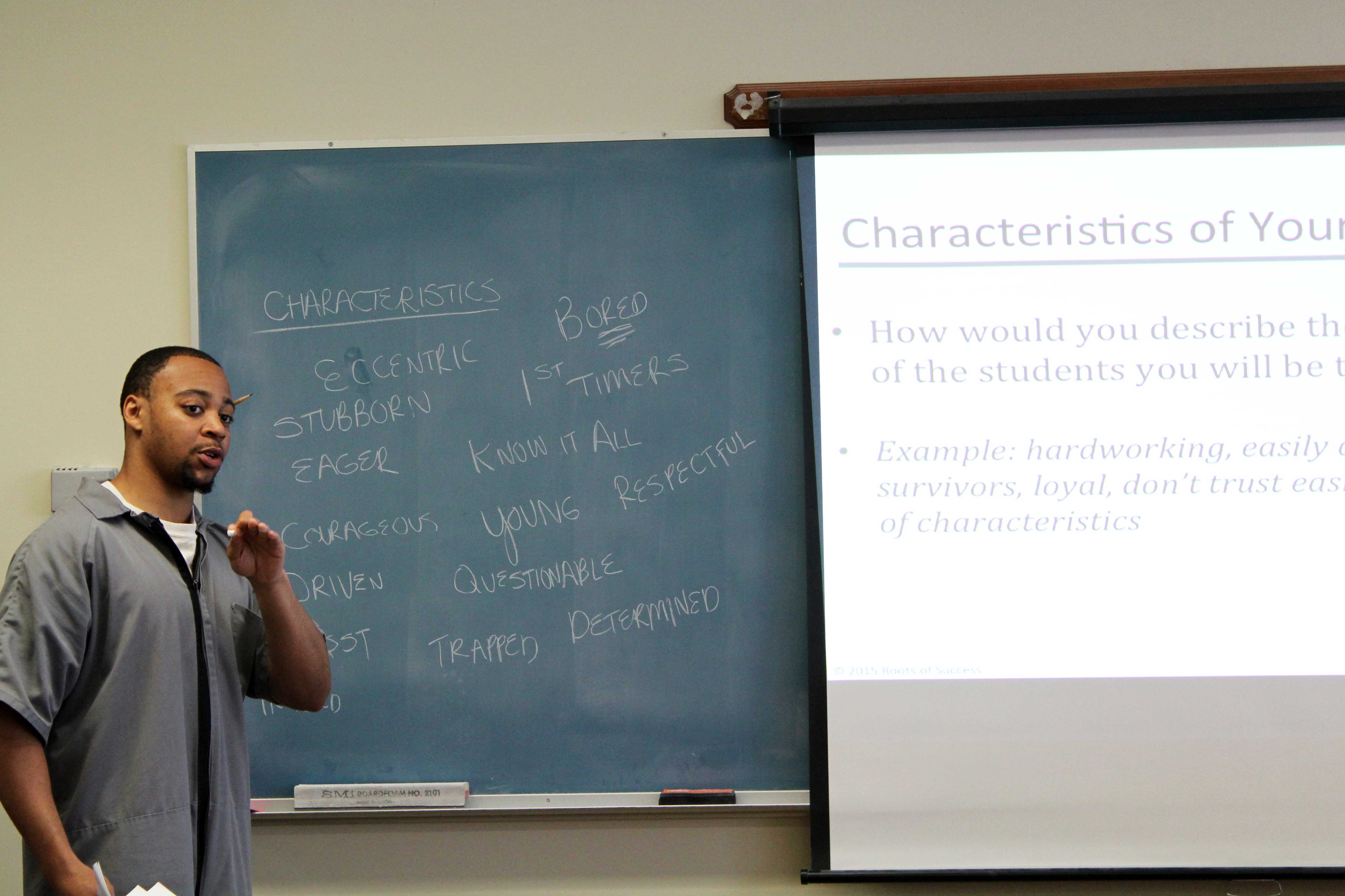 Roots instructors are most successful when they work as teaching teams. Here Cyril Walrond, Stafford Creek Roots Master Trainer, takes notes on the chalkboard and engages students as they describe the characteristics of their future students. Photo by Joslyn Rose Trivett.