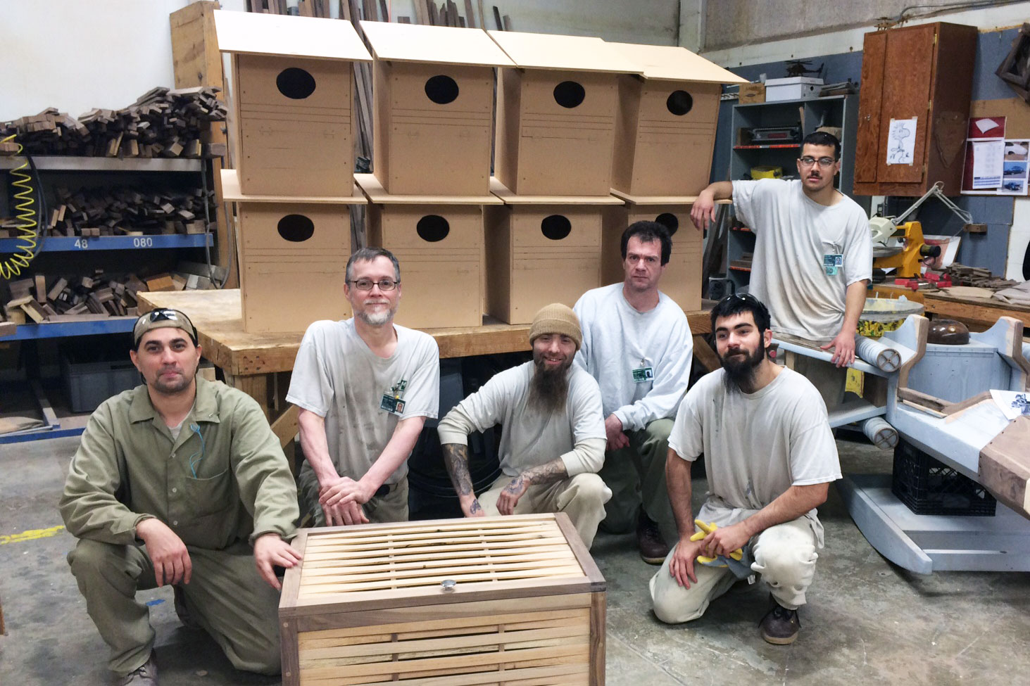 Roy Townsend, Michael Feeney, Robert Beck, Robert Haugen, Luke Andrade, and Jose Ayala pose with the barn owl next boxes they build in the Sustainable Practices Lab. Photo by DOC staff.