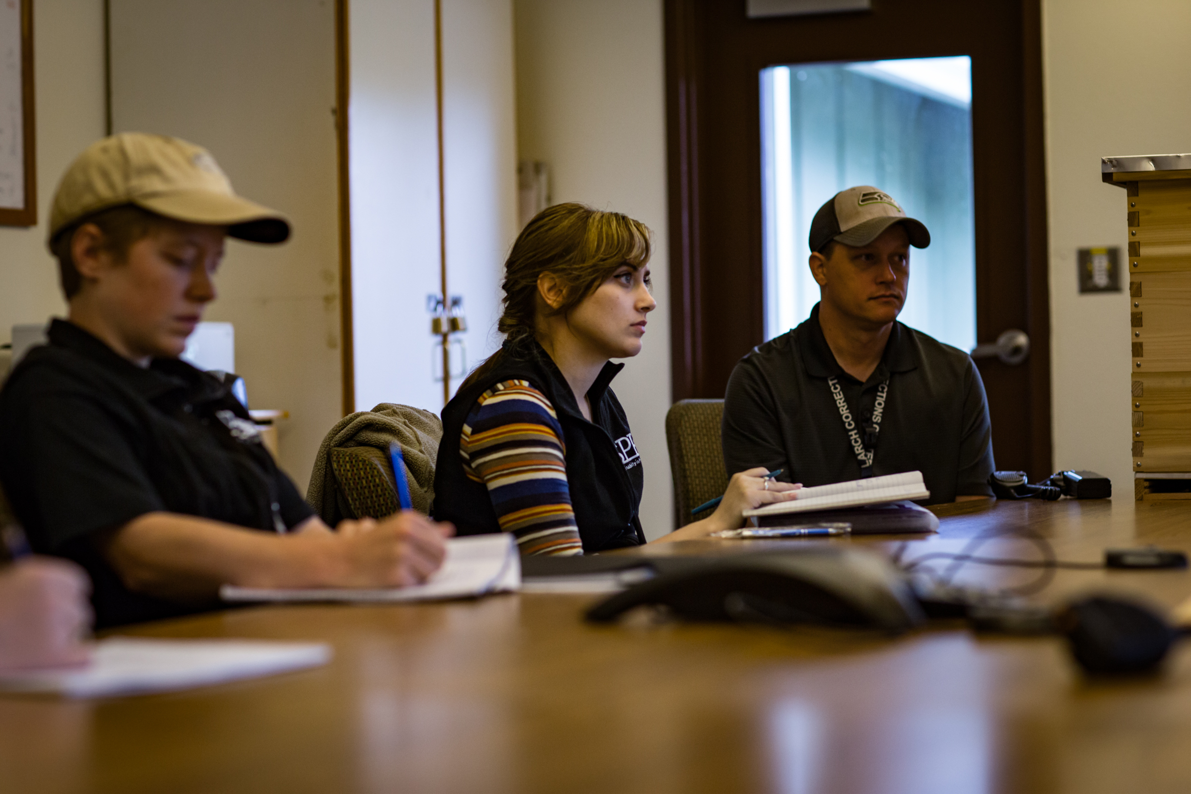 Sadie Gilliom, Emily Passarelli, and Shawn Piliponis discuss beekeeping at Larch. Photo by Ricky Osborne.