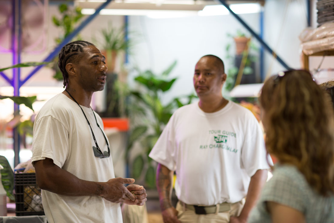 x technician talks about his work growing starts for the prison gardens and houseplants for the indoor spaces; his program area is one of many in Washington State Penitentiary's Sustainable Practice Lab. Photo by Ricky Osborne.