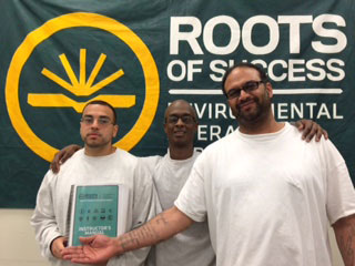 Roots instructors Julian Reyes, Jonathan Bolden, and Eugene Youngblood pose at a graduation event.